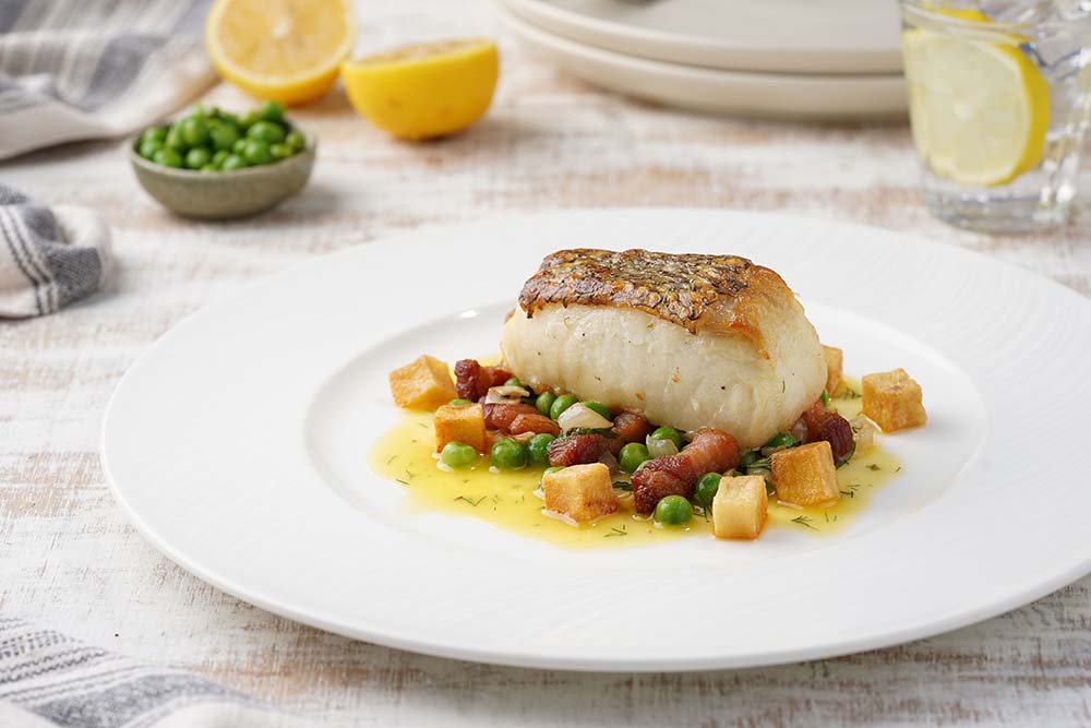 Pan Roasted Chilean Sea Bass Garden Peas and Pancetta Herb with Lemon Butter Sauce