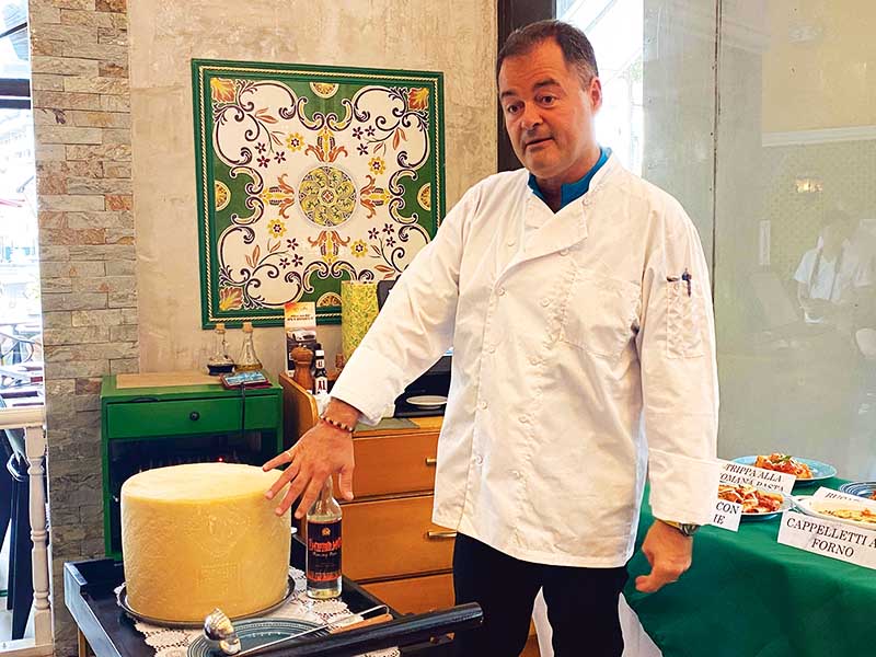 Chef Alessandro Carossi showcasing the Pecorino Romano Cheese Wheel bowl